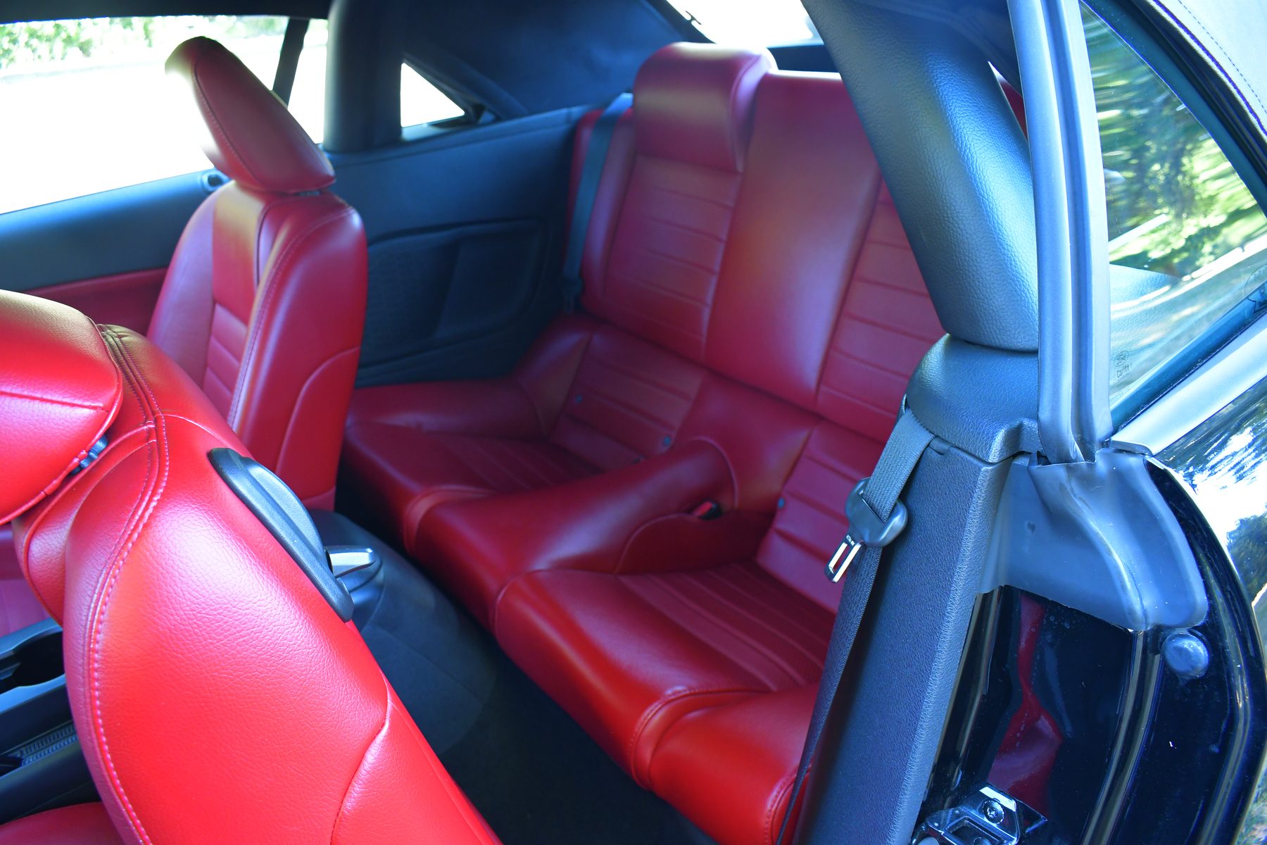 Rear three-quarter view, door open, top down